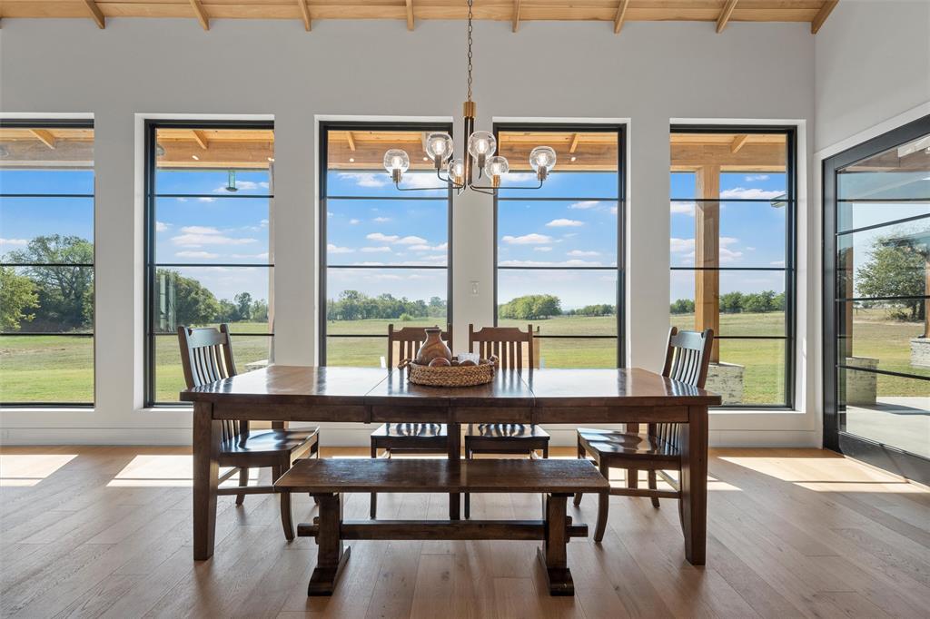 477 Wolf Creek Road Lorena, TX 76655 - Photo 11 of 40 a view of a dining room with furniture window and wooden floor