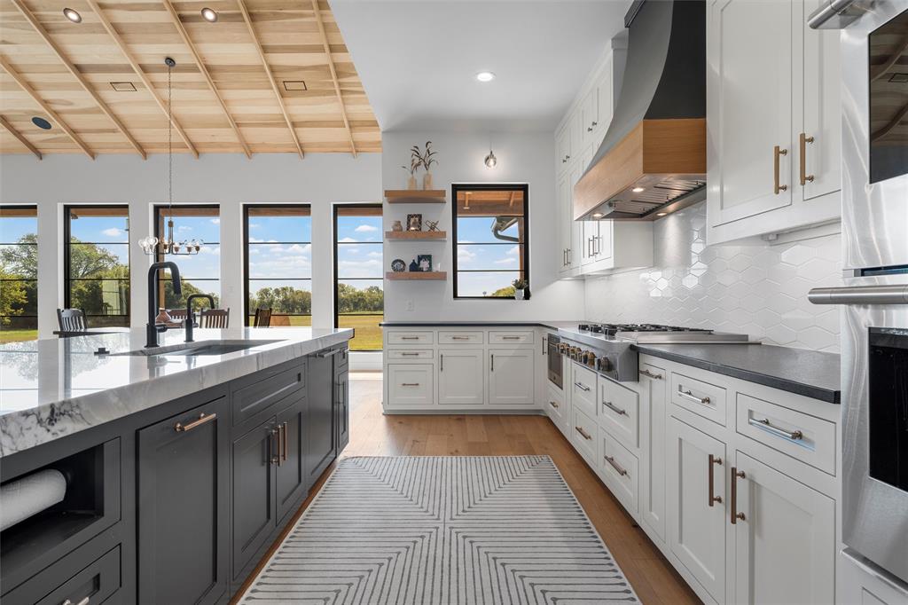 477 Wolf Creek Road Lorena, TX 76655 - Photo 14 of 40 a large kitchen with stainless steel appliances granite countertop a lot of counter space and a sink