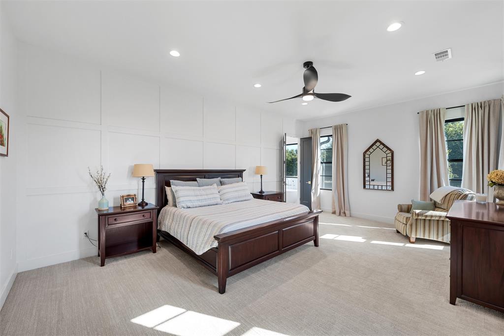 477 Wolf Creek Road Lorena, TX 76655 - Photo 16 of 40 a spacious bedroom with a bed a ceiling fan and a window