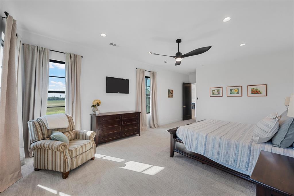 477 Wolf Creek Road Lorena, TX 76655 - Photo 17 of 40 a bedroom with a bed couch and a ceiling fan