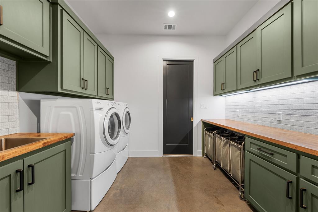 477 Wolf Creek Road Lorena, TX 76655 - Photo 20 of 40 a kitchen with stainless steel appliances granite countertop a sink and a washer dryer