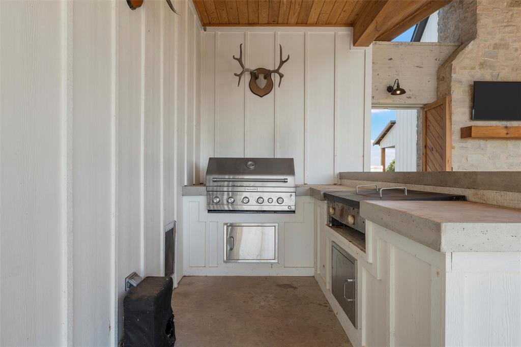 477 Wolf Creek Road Lorena, TX 76655 - Photo 24 of 40 a kitchen with a stove and a microwave