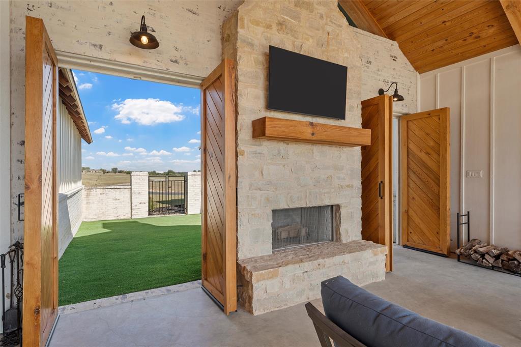 477 Wolf Creek Road Lorena, TX 76655 - Photo 25 of 40 a living room with a fireplace furniture and a large window