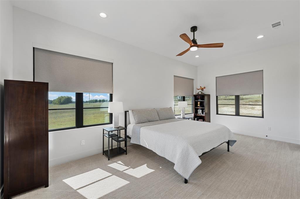 477 Wolf Creek Road Lorena, TX 76655 - Photo 26 of 40 a bedroom with a large bed and a large window