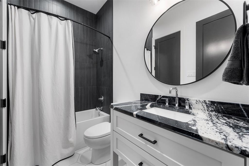 477 Wolf Creek Road Lorena, TX 76655 - Photo 29 of 40 a bathroom with a granite countertop sink and a mirror