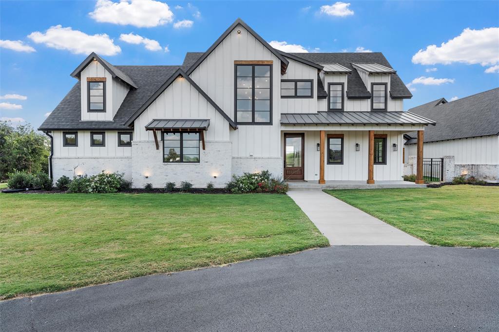 477 Wolf Creek Road Lorena, TX 76655 - Photo 6 of 40 a front view of a house with a garden and yard