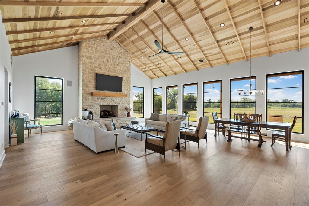 477 Wolf Creek Road Lorena, TX 76655 - Photo 9 of 40 a living room with furniture large wooden floor and a fireplace