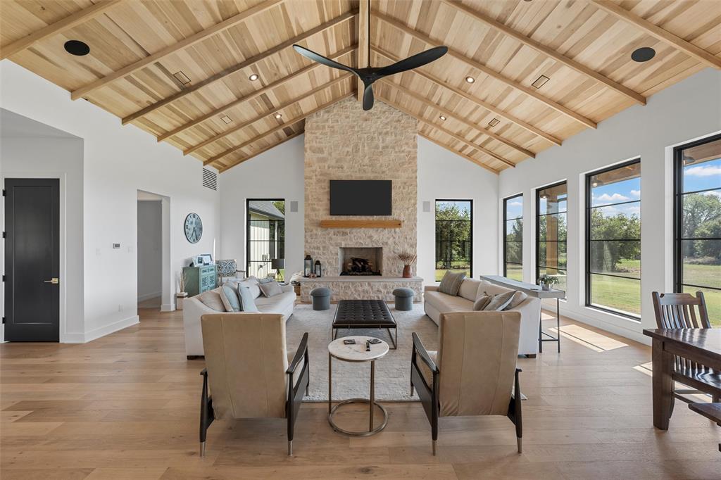 477 Wolf Creek Road Lorena, TX 76655 - Photo 10 of 40 a living room with furniture a fireplace and a chandelier