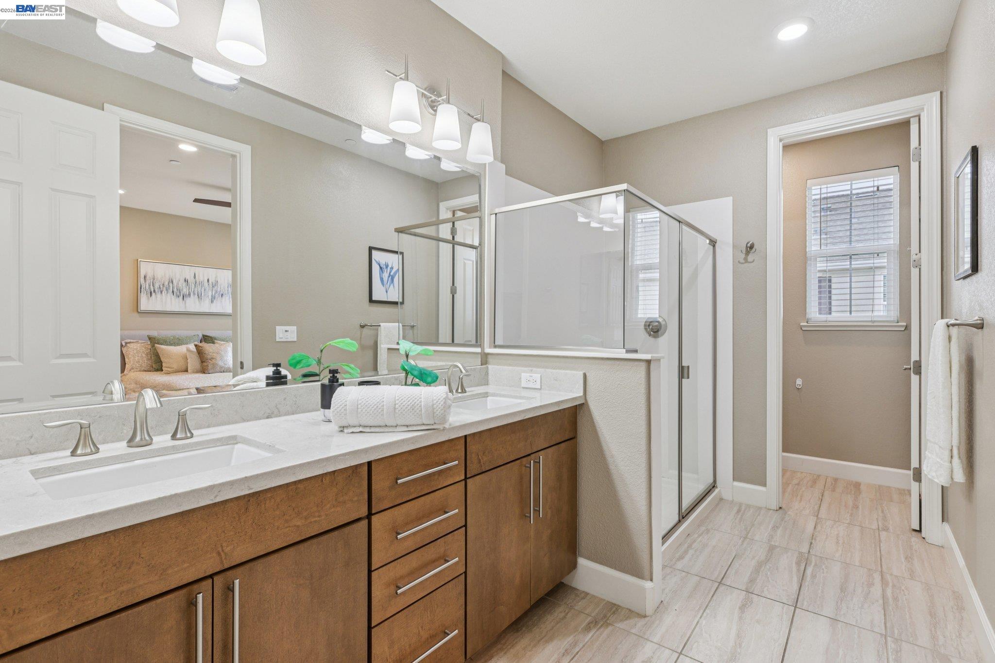 4022 Windsor Way Dublin, CA 94568 - Photo 17 of 55 a bathroom with a double vanity sink a mirror and a shower