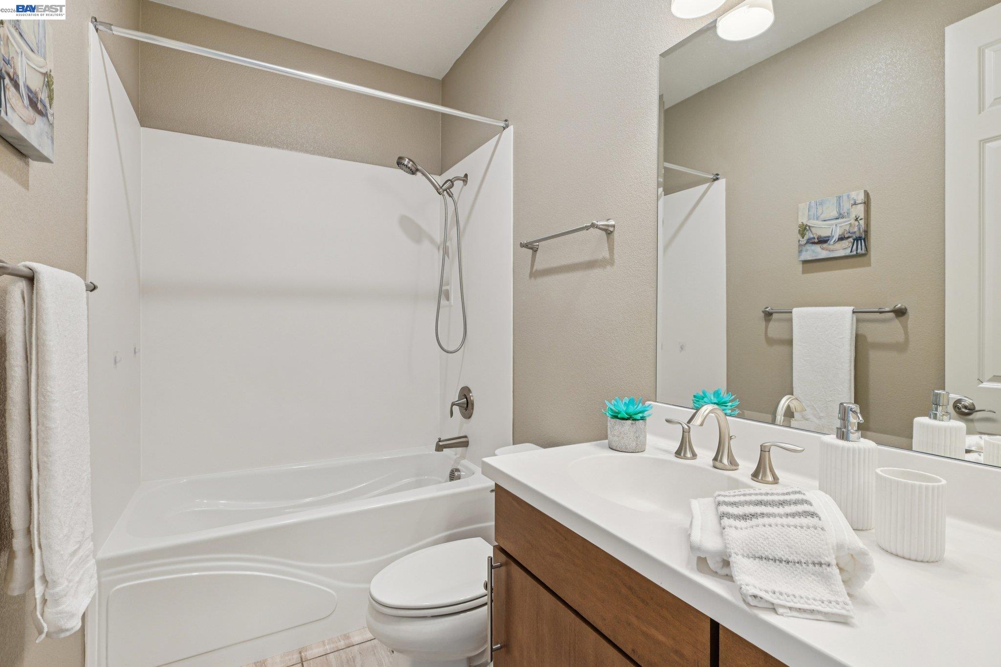 4022 Windsor Way Dublin, CA 94568 - Photo 23 of 55 a bathroom with a sink a toilet and a bathtub