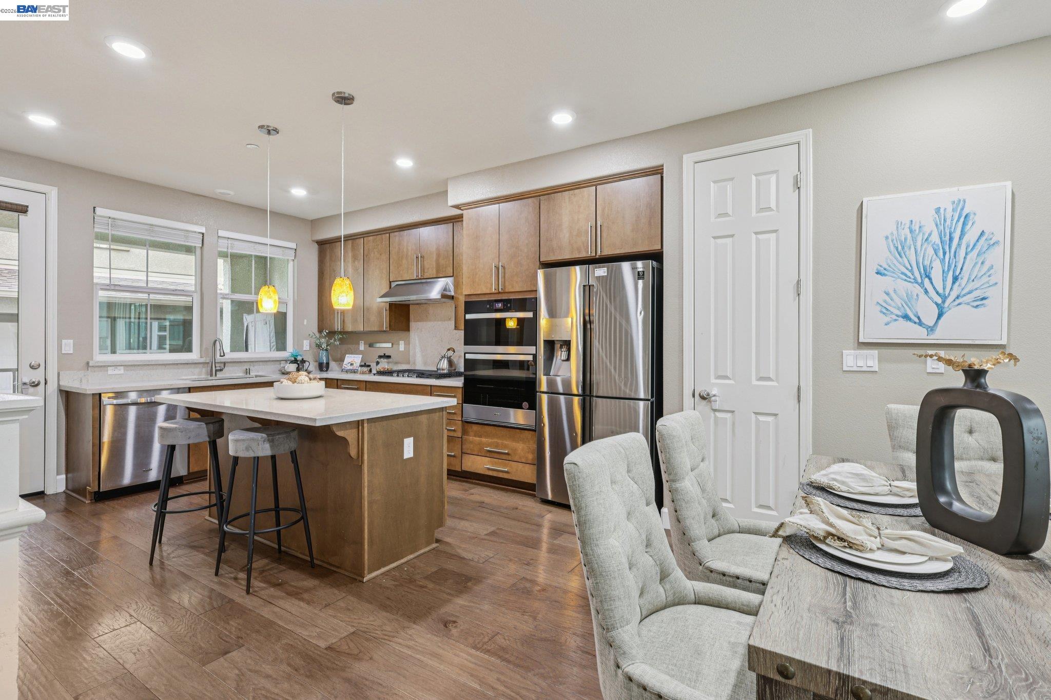 4022 Windsor Way Dublin, CA 94568 - Photo 8 of 55 a kitchen with stainless steel appliances granite countertop a sink a stove a refrigerator cabinets and dining table