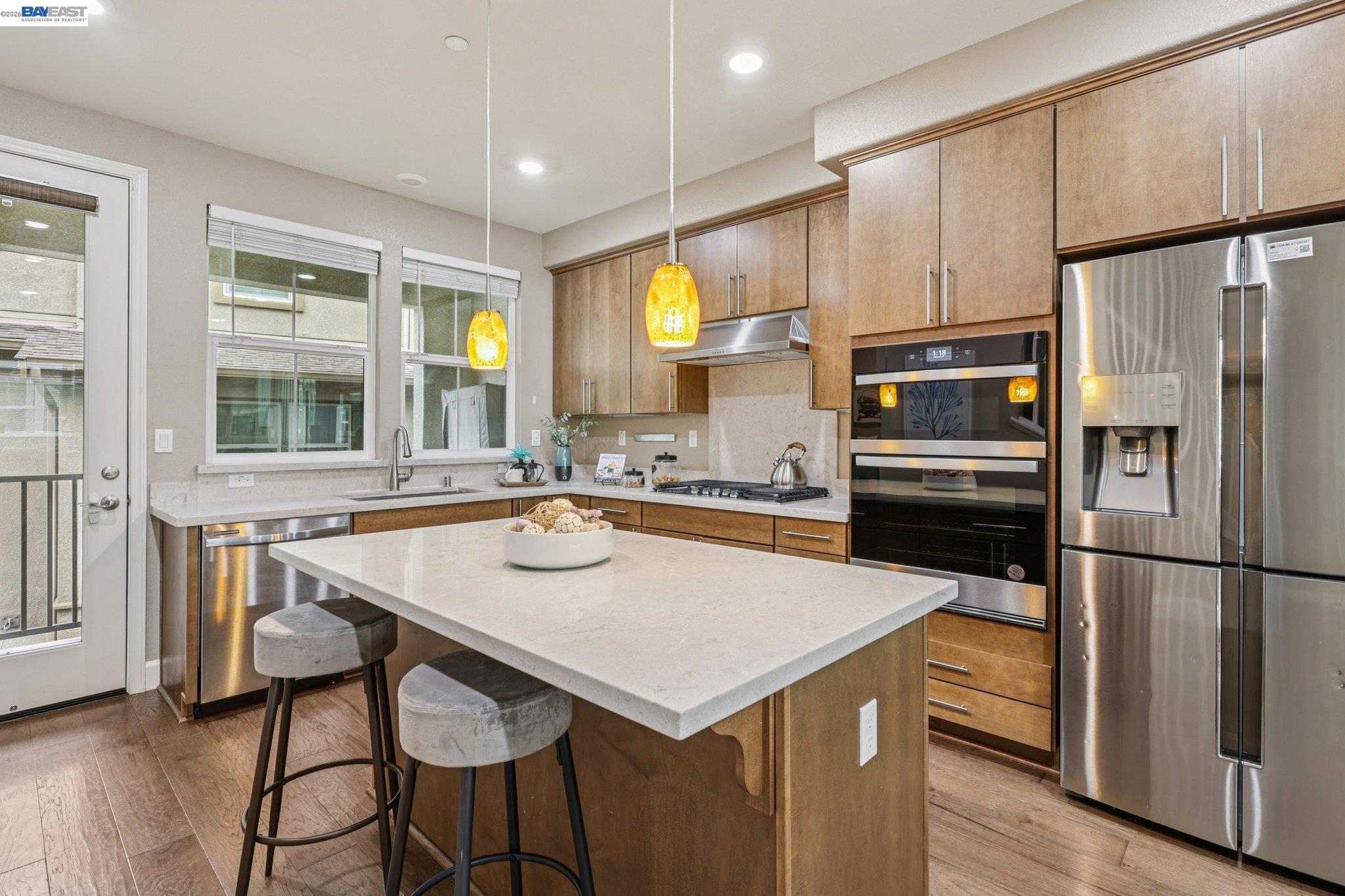 4022 Windsor Way Dublin, CA 94568 - Photo 9 of 55 a kitchen with a sink a kitchen island and stainless steel appliances