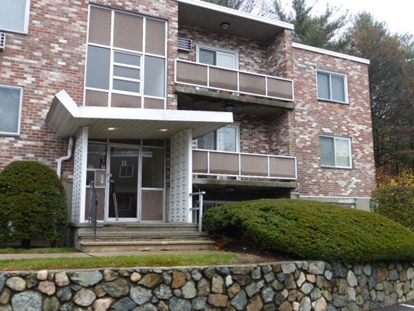 11 Jacqueline Road, Unit D Waltham, MA 02452 - Photo 1 of 13 a view of a house with potted plants and a yard