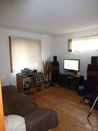11 Jacqueline Road, Unit D Waltham, MA 02452 - Photo 7 of 13 a living room with furniture and a flat screen tv