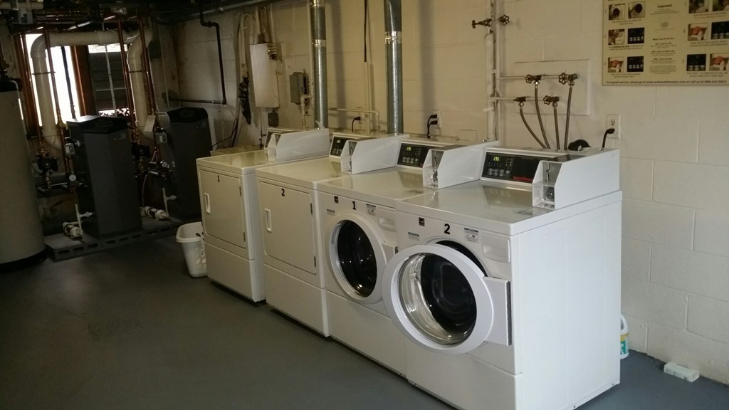 11 Jacqueline Road, Unit D Waltham, MA 02452 - Photo 9 of 13 a utility room with multiple dryer and washer