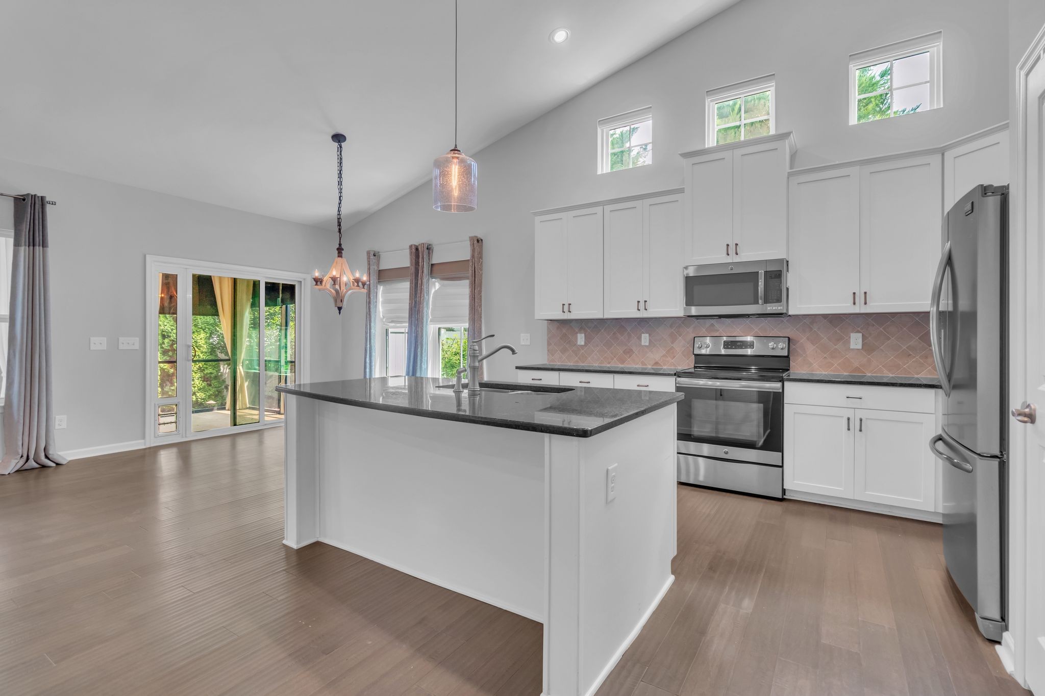 2827 Kellner Drive Murfreesboro, TN 37128 - Photo 12 of 26 a kitchen with stainless steel appliances a sink a stove a refrigerator cabinets and a wooden floor