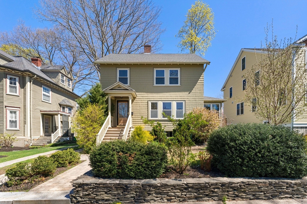 a front view of a house with garden