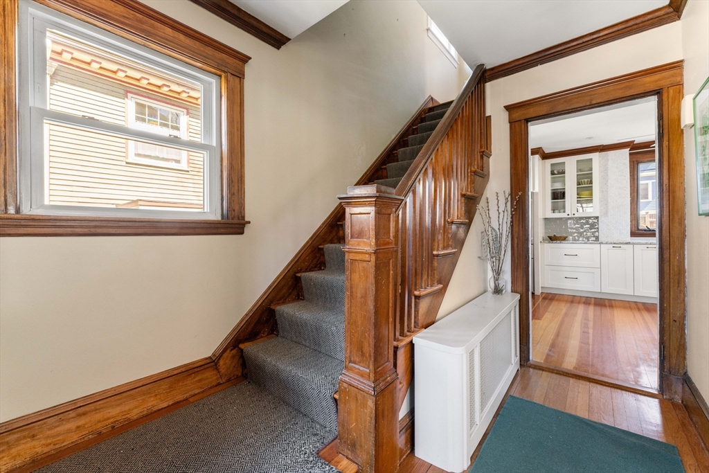 136 Beech Street Boston, MA 02131 - Photo 20 of 40 a view of an entryway with wooden floor and stairs