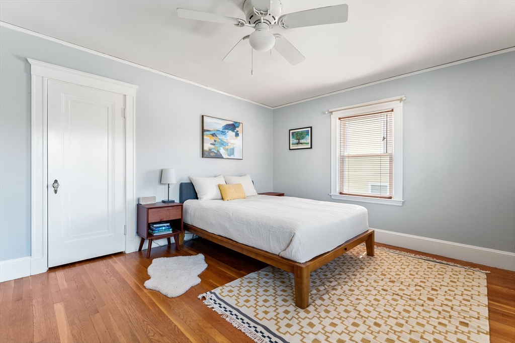 136 Beech Street Boston, MA 02131 - Photo 23 of 40 a bedroom with a bed and a table in it