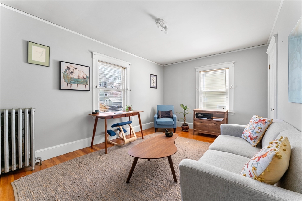 136 Beech Street Boston, MA 02131 - Photo 26 of 40 a living room with furniture a rug and a window
