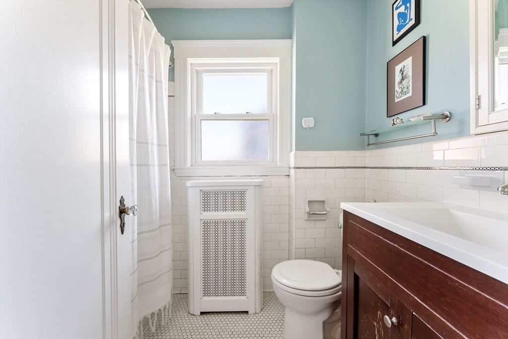 136 Beech Street Boston, MA 02131 - Photo 29 of 40 a bathroom with a sink a toilet and shower