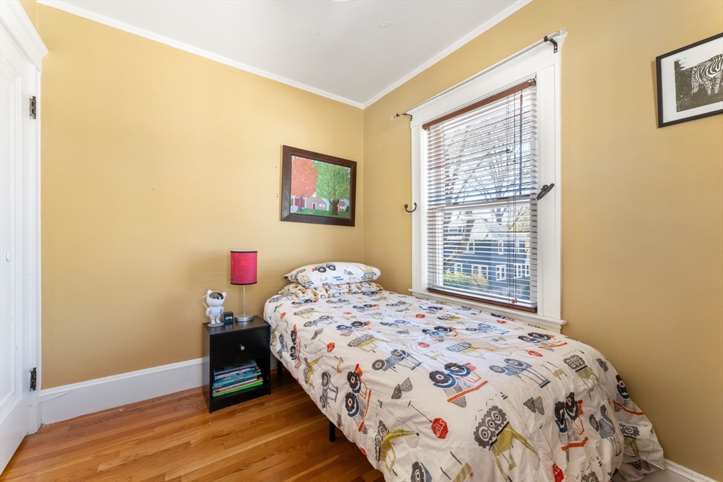 136 Beech Street Boston, MA 02131 - Photo 31 of 40 a bedroom with a bed and a window