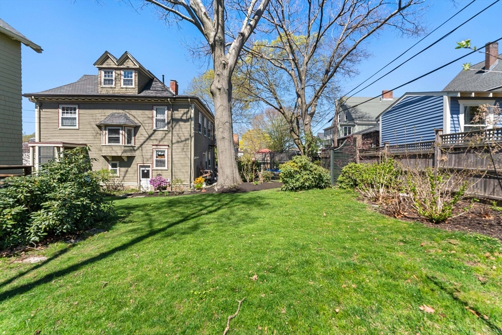 136 Beech Street Boston, MA 02131 - Photo 37 of 40 a front view of a house with garden