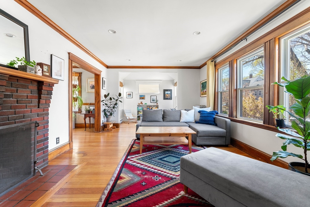 136 Beech Street Boston, MA 02131 - Photo 4 of 40 a living room with furniture and a fireplace