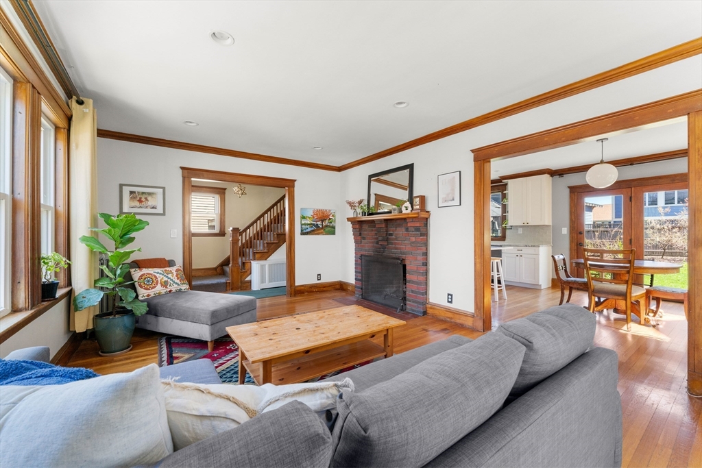 136 Beech Street Boston, MA 02131 - Photo 7 of 40 a living room with furniture and a fireplace