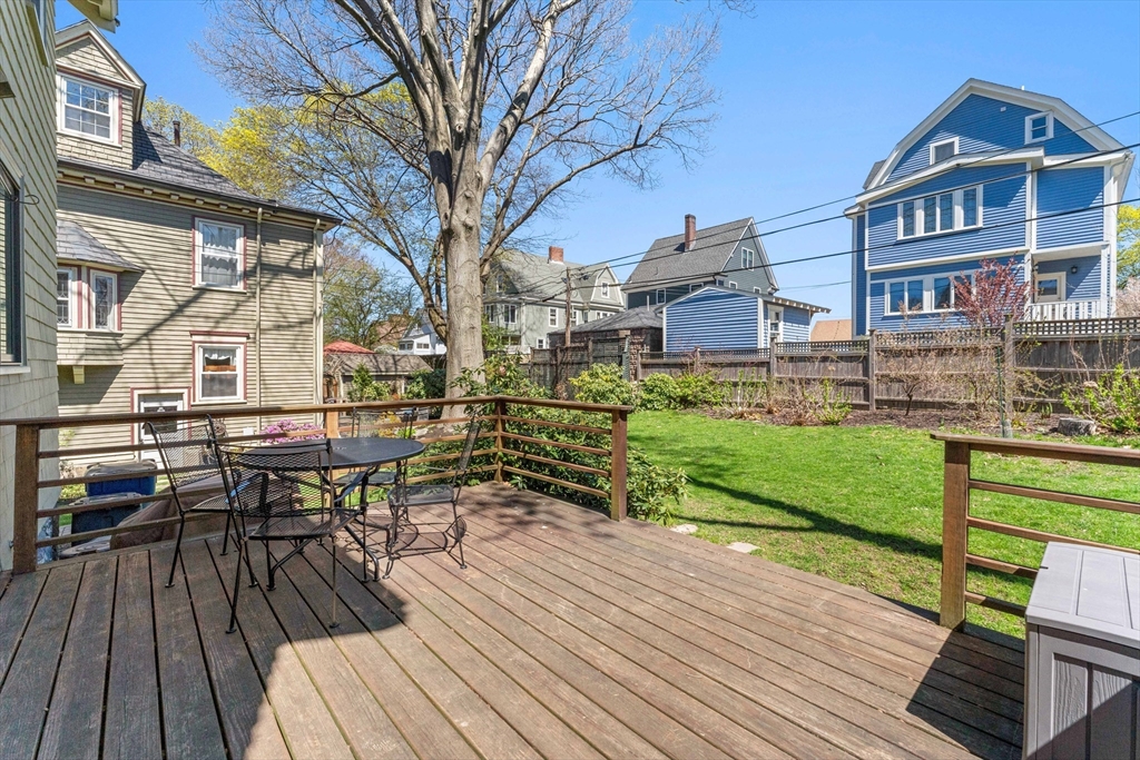 136 Beech Street Boston, MA 02131 - Photo 9 of 40 a view of a house with a patio and wooden flooring