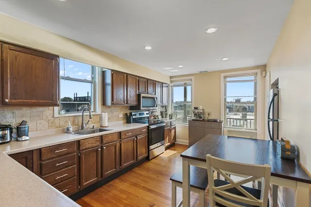 a kitchen with lots of counter top space and wooden floor