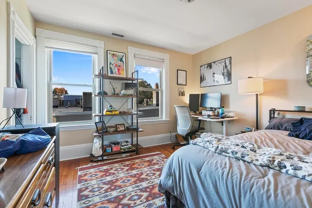a bedroom with furniture and a fireplace