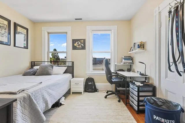 a bedroom with a bed and a desk