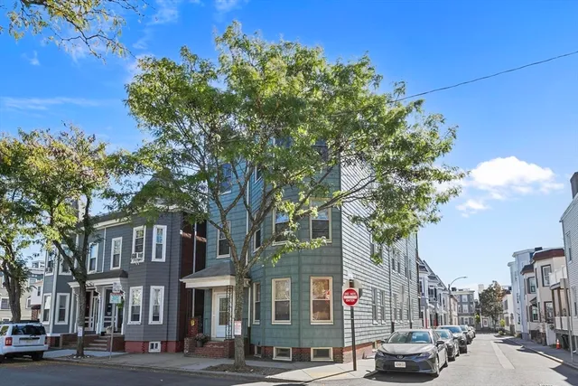a city street lined with buildings and trees