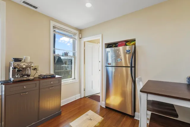 a kitchen with stainless steel appliances granite countertop a refrigerator and a stove