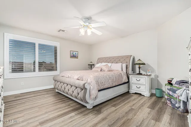 a bedroom with a bed and a chandelier