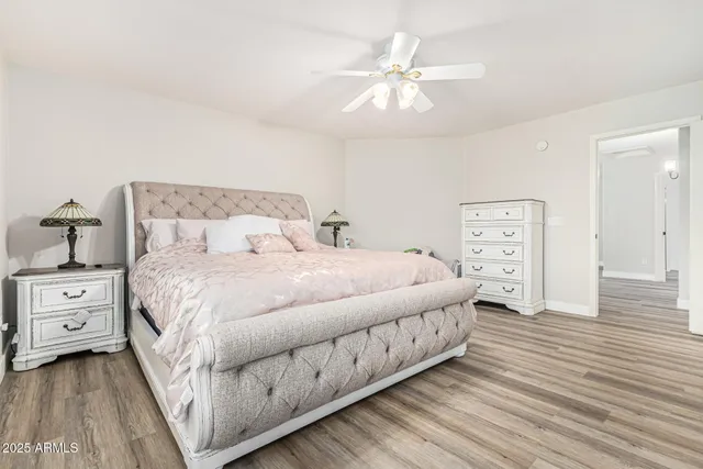 a bedroom with a large bed and a chandelier