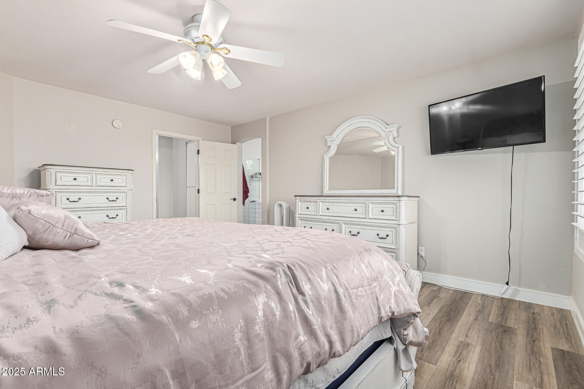 1038 East Harrison Court Gilbert, AZ 85295 - Photo 14 of 27 a bedroom with a bed and a flat screen tv