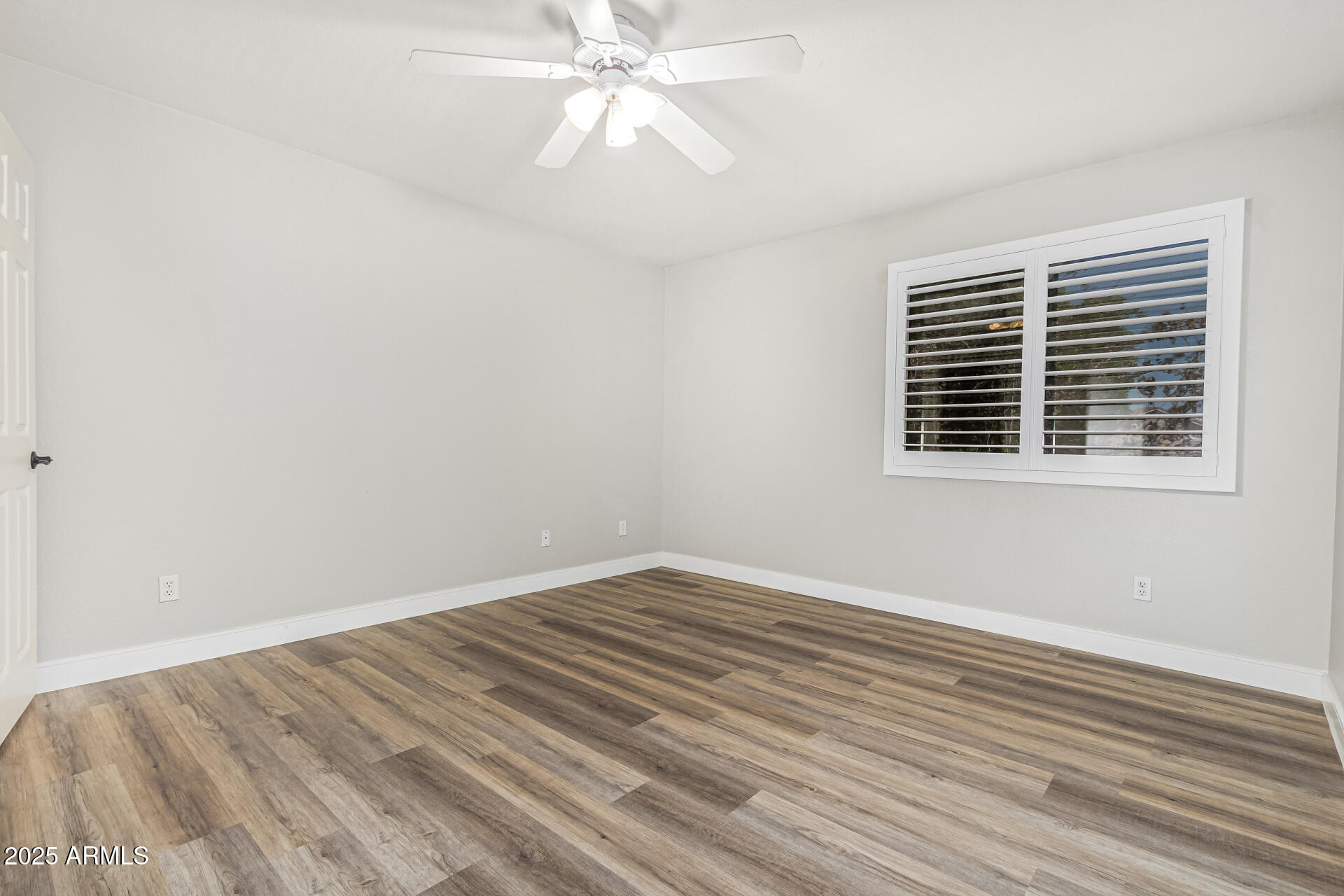 1038 East Harrison Court Gilbert, AZ 85295 - Photo 18 of 27 a view of empty room with wooden floor and fan