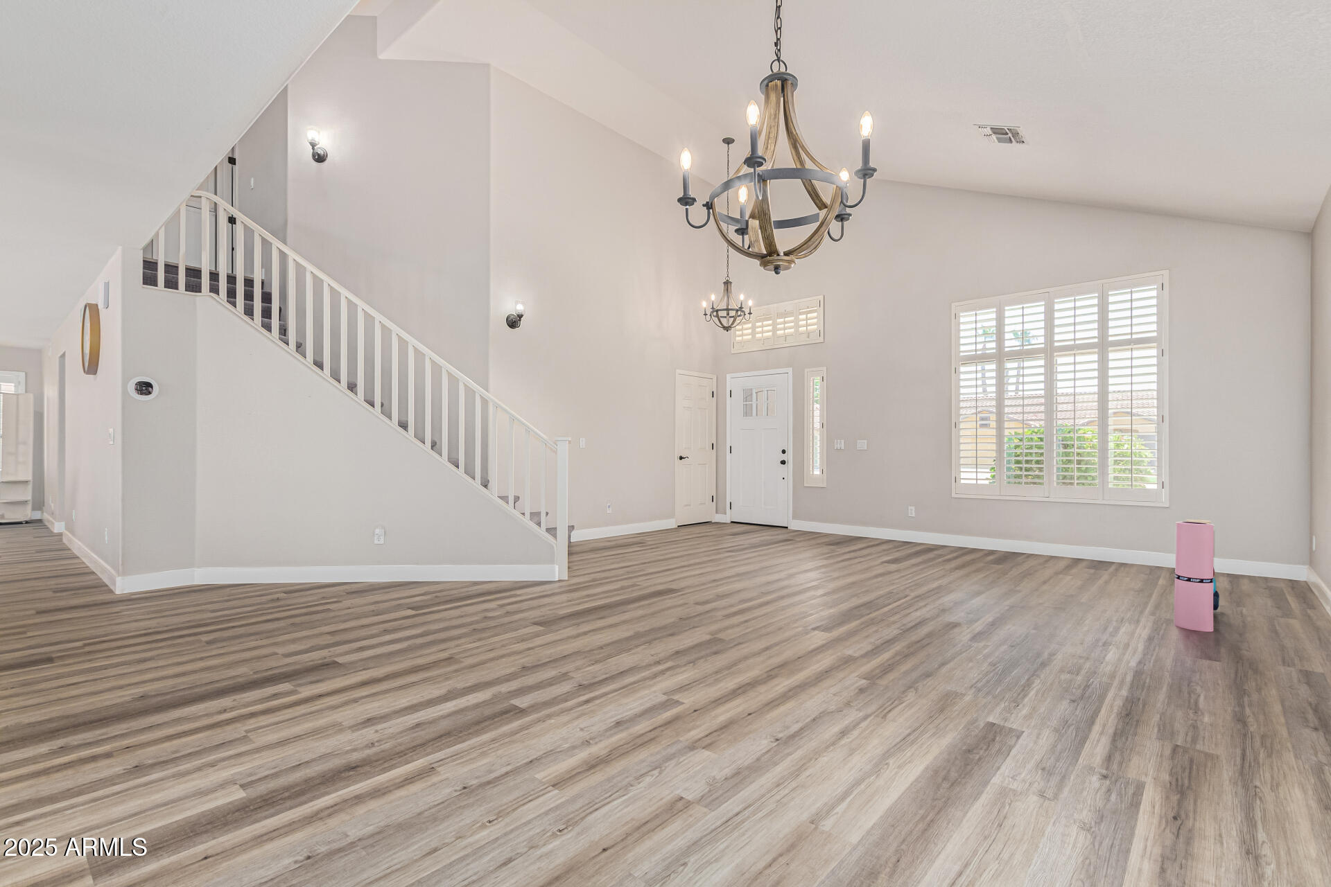 1038 East Harrison Court Gilbert, AZ 85295 - Photo 2 of 27 a view of an empty room with wooden floor and a window