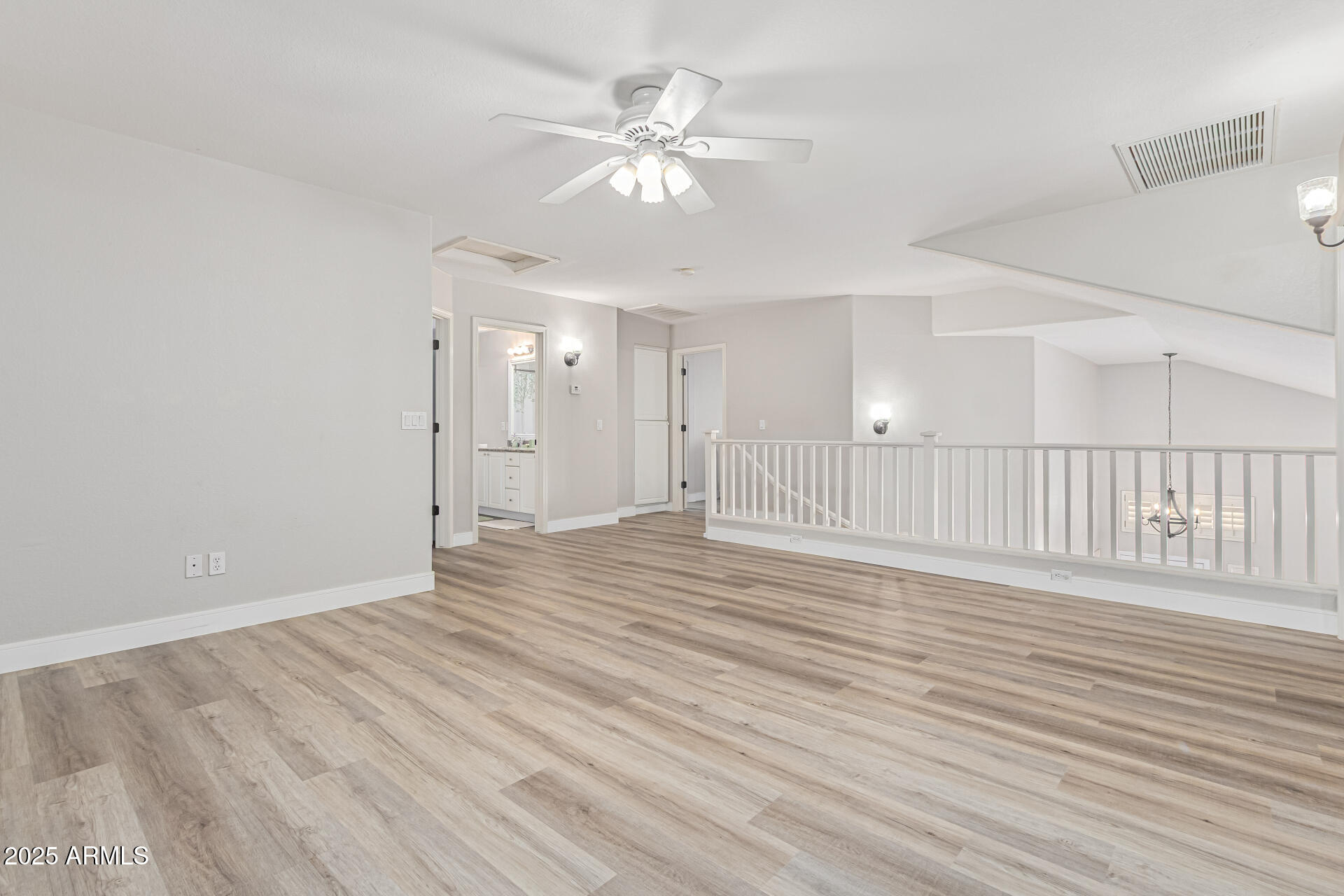 1038 East Harrison Court Gilbert, AZ 85295 - Photo 22 of 27 a view of an empty room with wooden floor and a ceiling fan