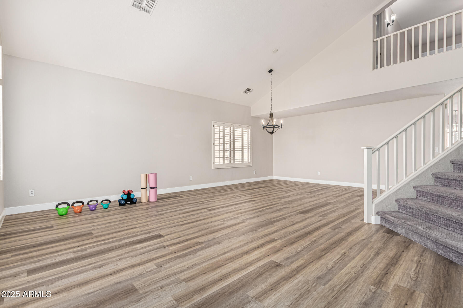 1038 East Harrison Court Gilbert, AZ 85295 - Photo 4 of 27 a view of an empty room with wooden floor and a window