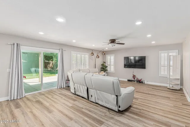 a spacious bedroom with a large bed and a flat screen tv