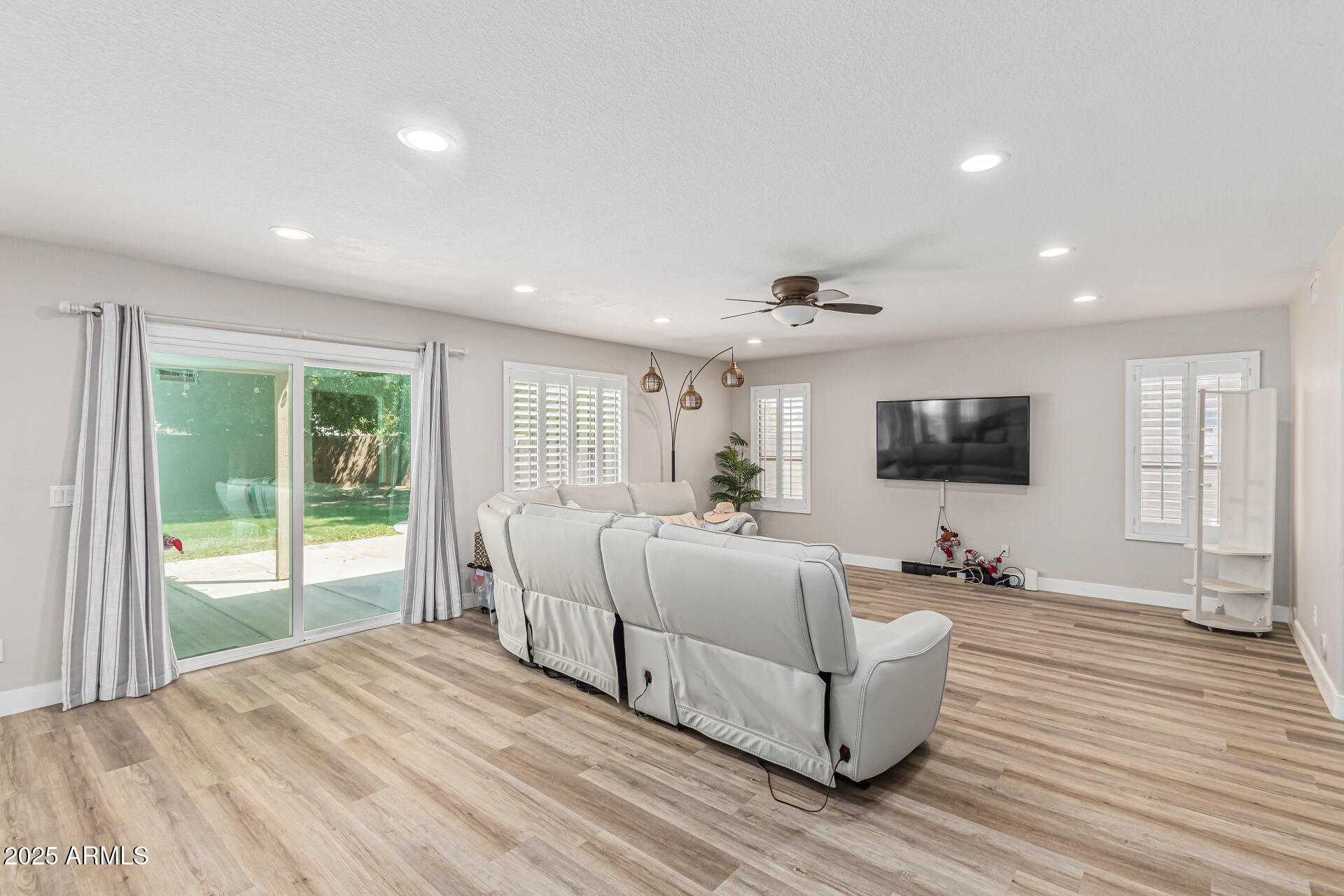 1038 East Harrison Court Gilbert, AZ 85295 - Photo 6 of 27 a spacious bedroom with a large bed and a flat screen tv