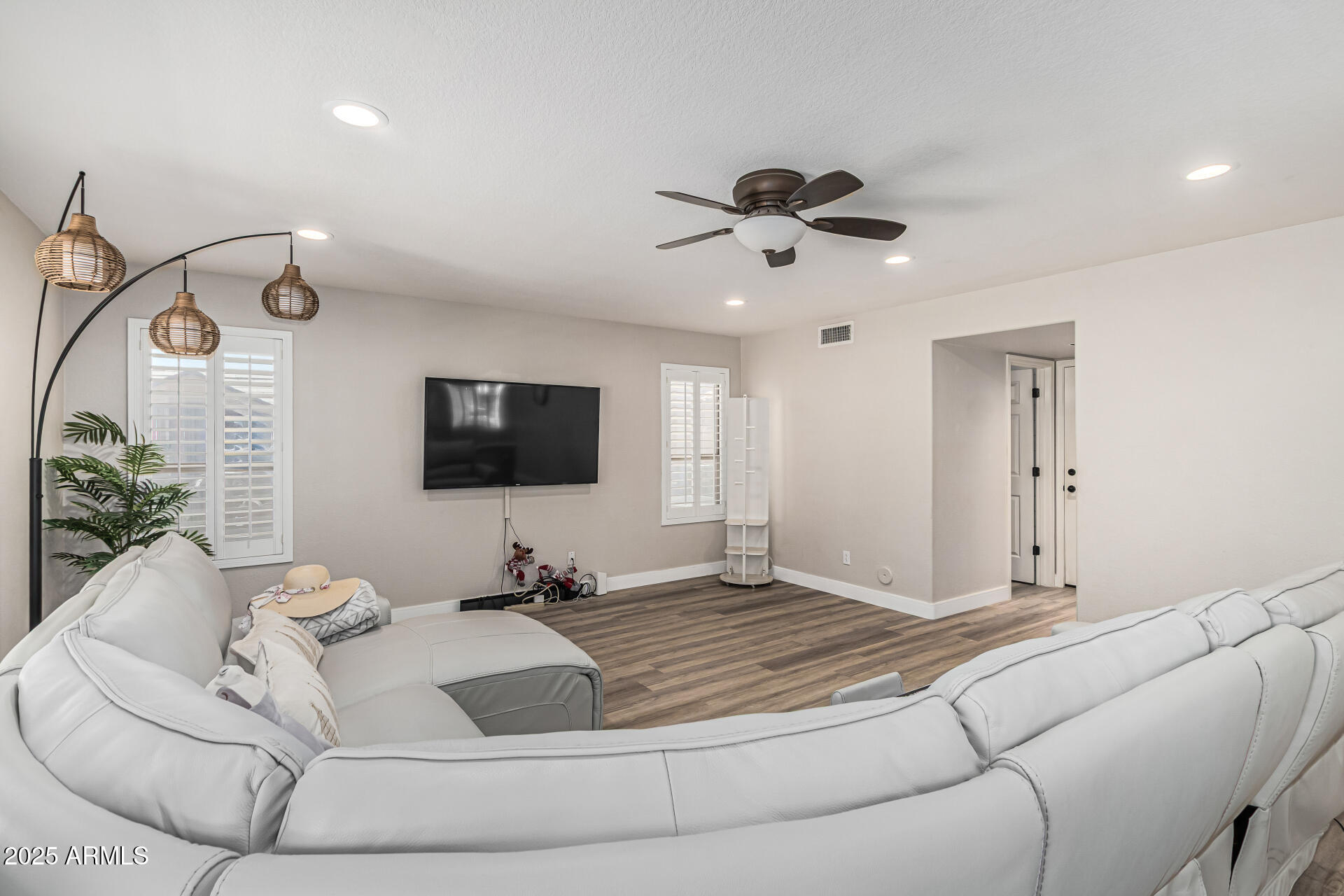 1038 East Harrison Court Gilbert, AZ 85295 - Photo 7 of 27 a living room with a bed furniture and a flat screen tv