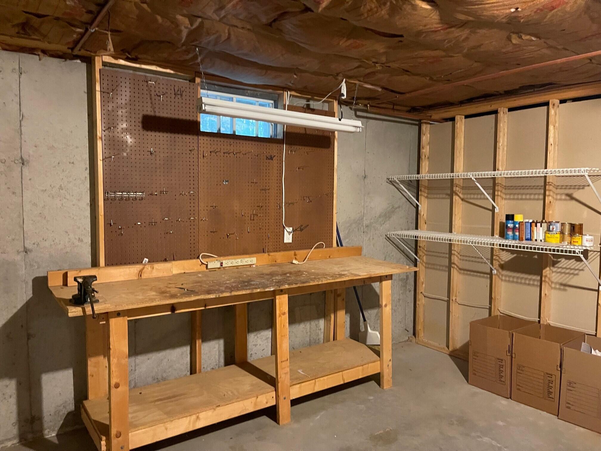 19 Windsor Commons Drive, Unit 19 Kennebunk, ME 04043 - Photo 58 of 68 Workbench & shelving remain