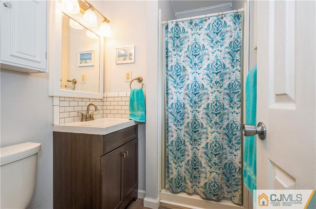 70 Wilk Road Edison, NJ 08837 - Photo 14 of 24 a bathroom with a sink and a mirror