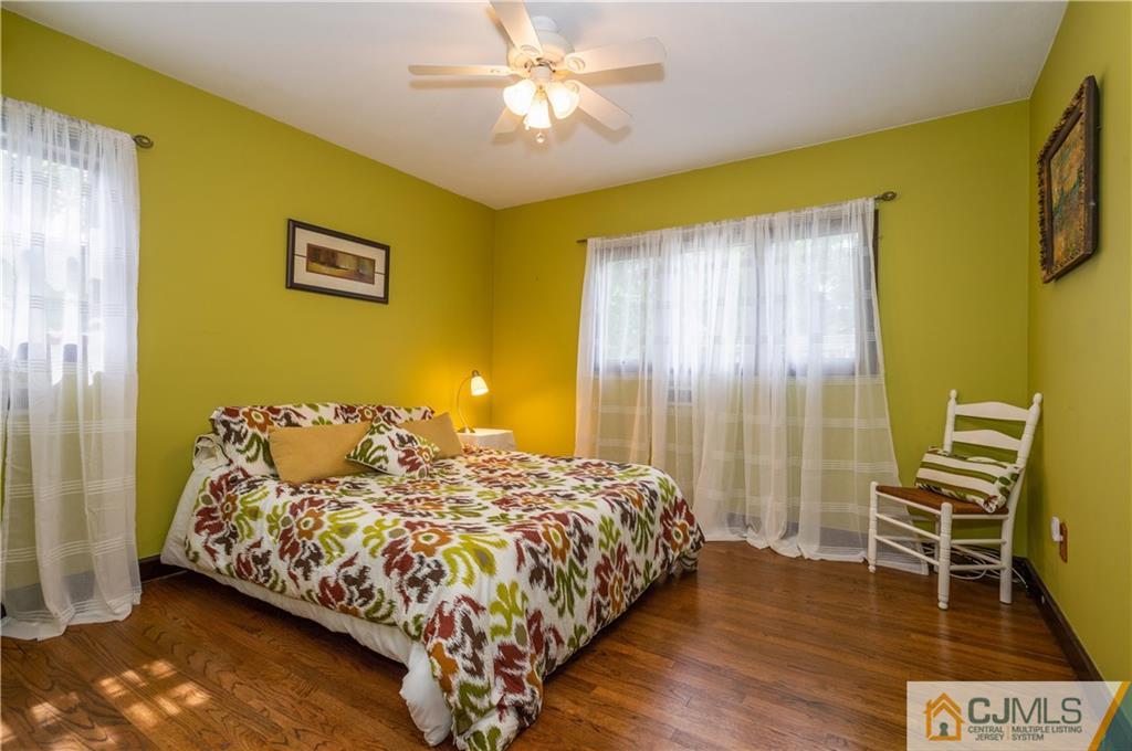 70 Wilk Road Edison, NJ 08837 - Photo 15 of 24 a bedroom with a bed and a chandelier