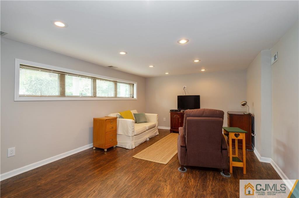 70 Wilk Road Edison, NJ 08837 - Photo 18 of 24 a living room with furniture and a flat screen tv