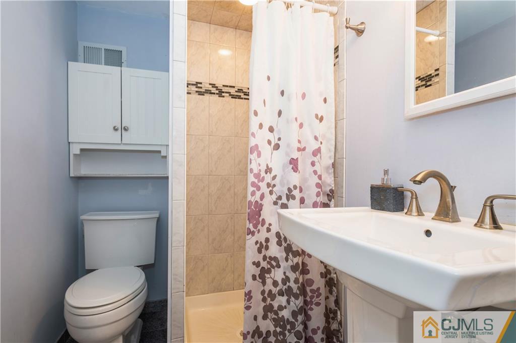 70 Wilk Road Edison, NJ 08837 - Photo 20 of 24 a bathroom with a sink toilet and shower